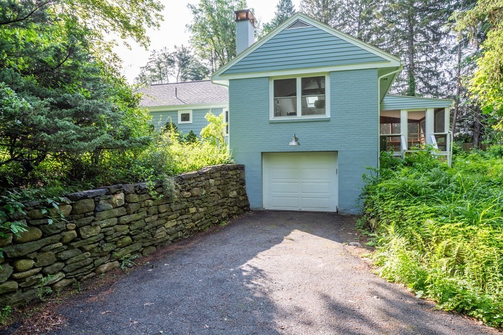 90 Memorial Drive Amherst, MA 01002 - Photo 3 of 38 a front view of a house with a yard and garage