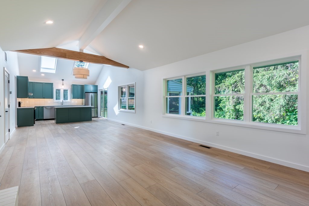 90 Memorial Drive Amherst, MA 01002 - Photo 6 of 38 an empty room with wooden floor and windows
