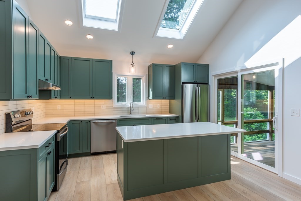 90 Memorial Drive Amherst, MA 01002 - Photo 8 of 38 a large kitchen with kitchen island a sink stainless steel appliances and cabinets