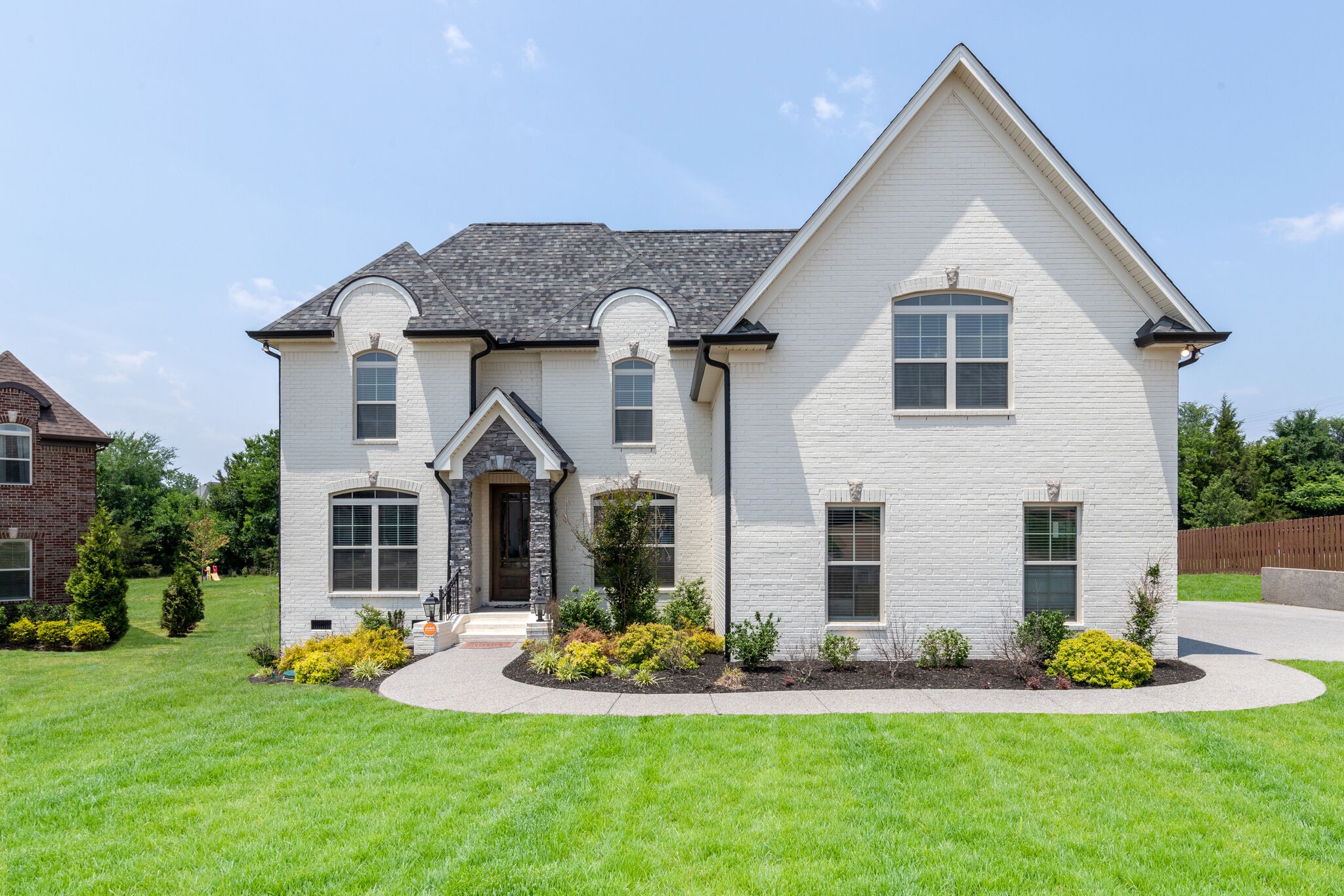a front view of house with yard outdoor seating and garage
