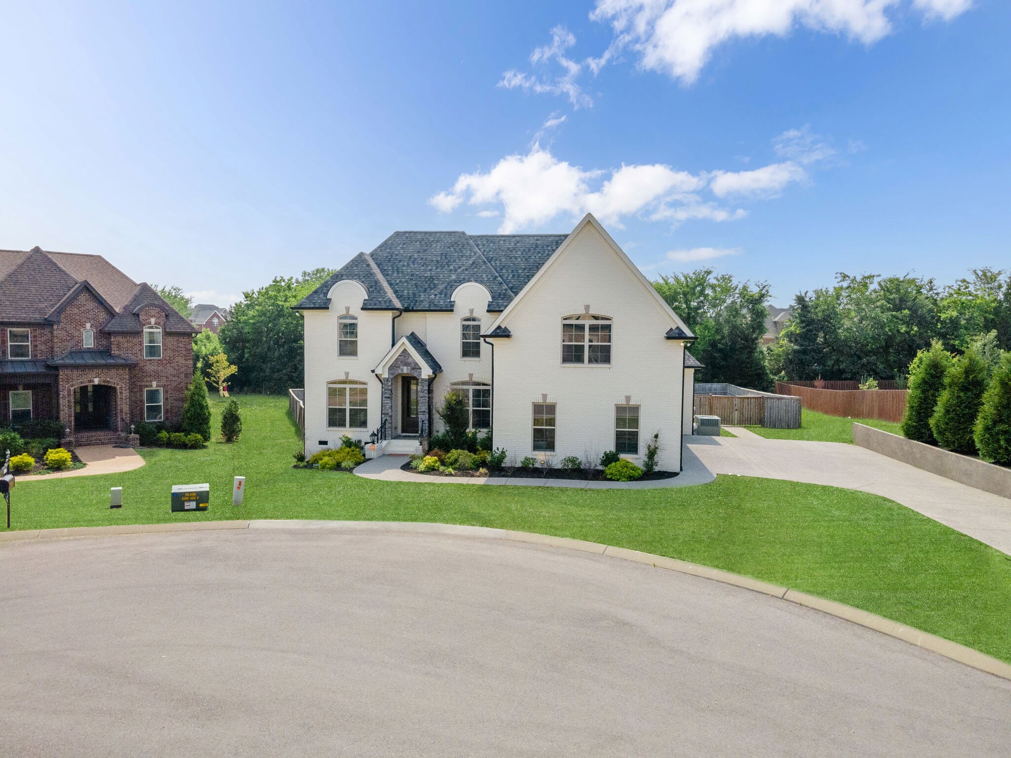 2002 Beechhaven Cir Mount Mount Juliet, TN 37122 - Photo 13 of 57 a view of a white house next to a yard and a large tree