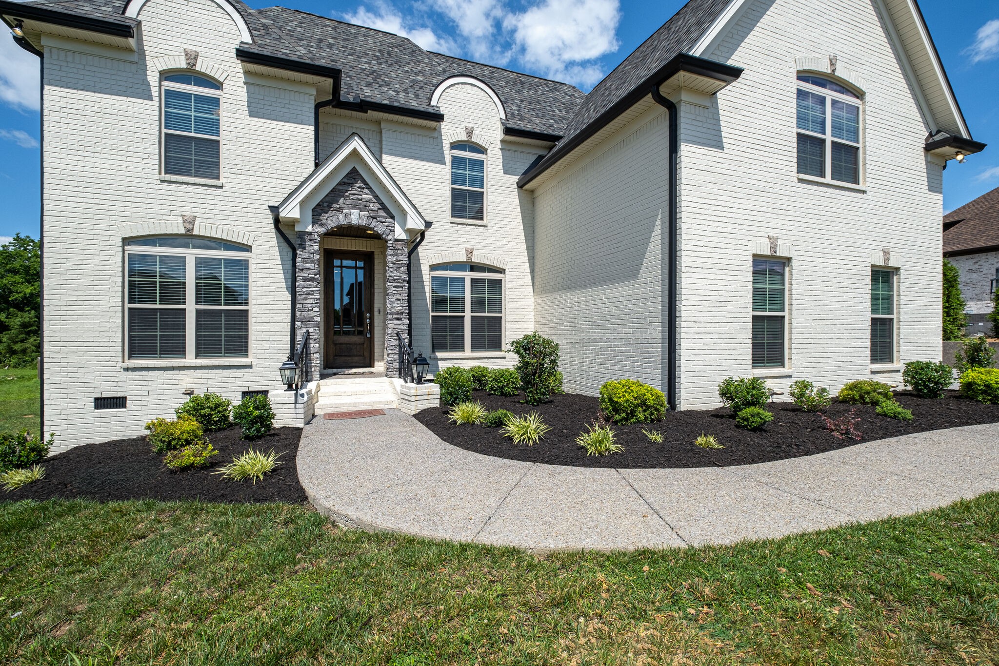 2002 Beechhaven Cir Mount Mount Juliet, TN 37122 - Photo 18 of 57 a front view of a house with a garden