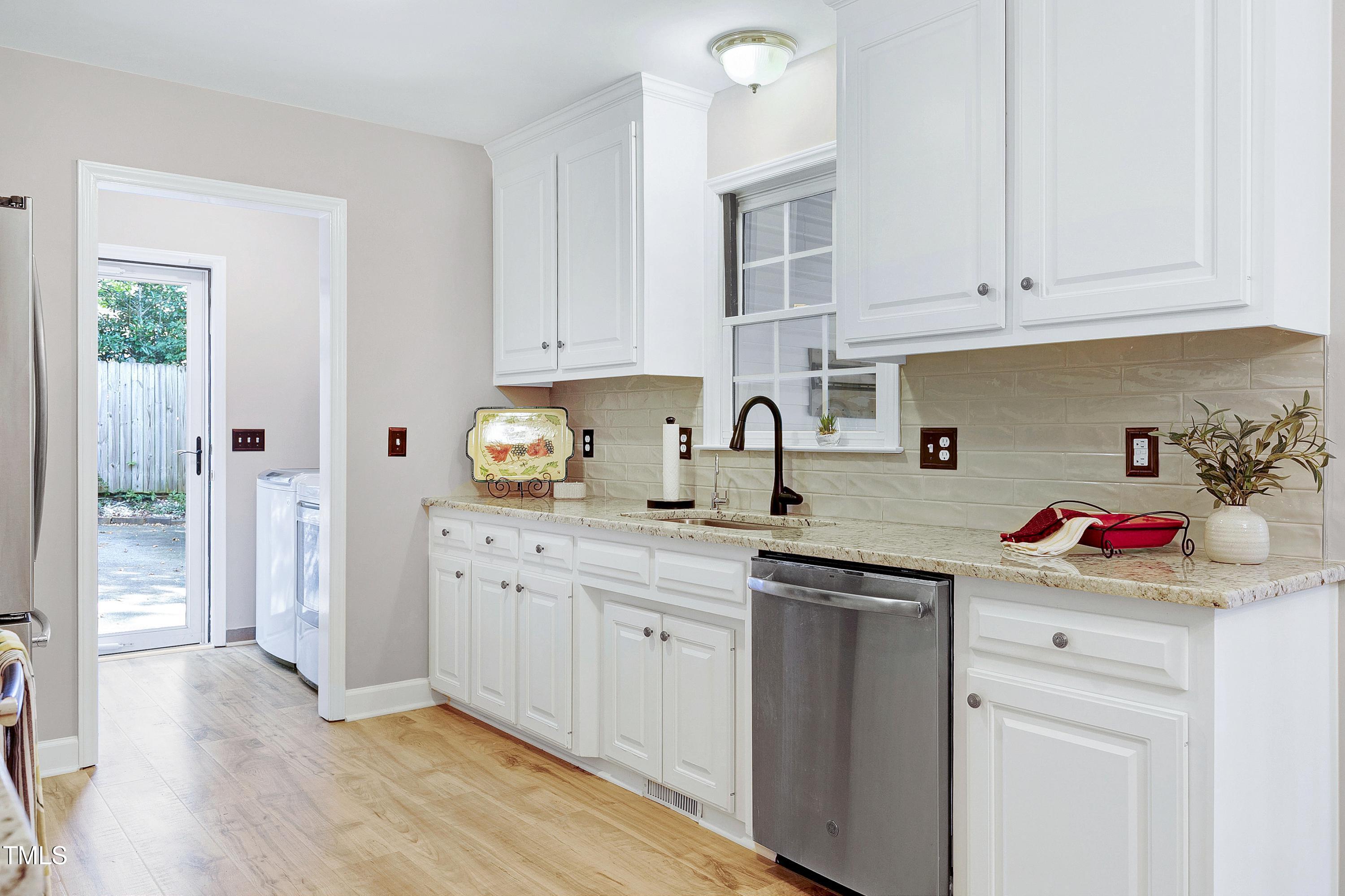7834 James Austin Road Willow Spring, NC 27592 - Photo 12 of 46 a kitchen with white cabinets and sink