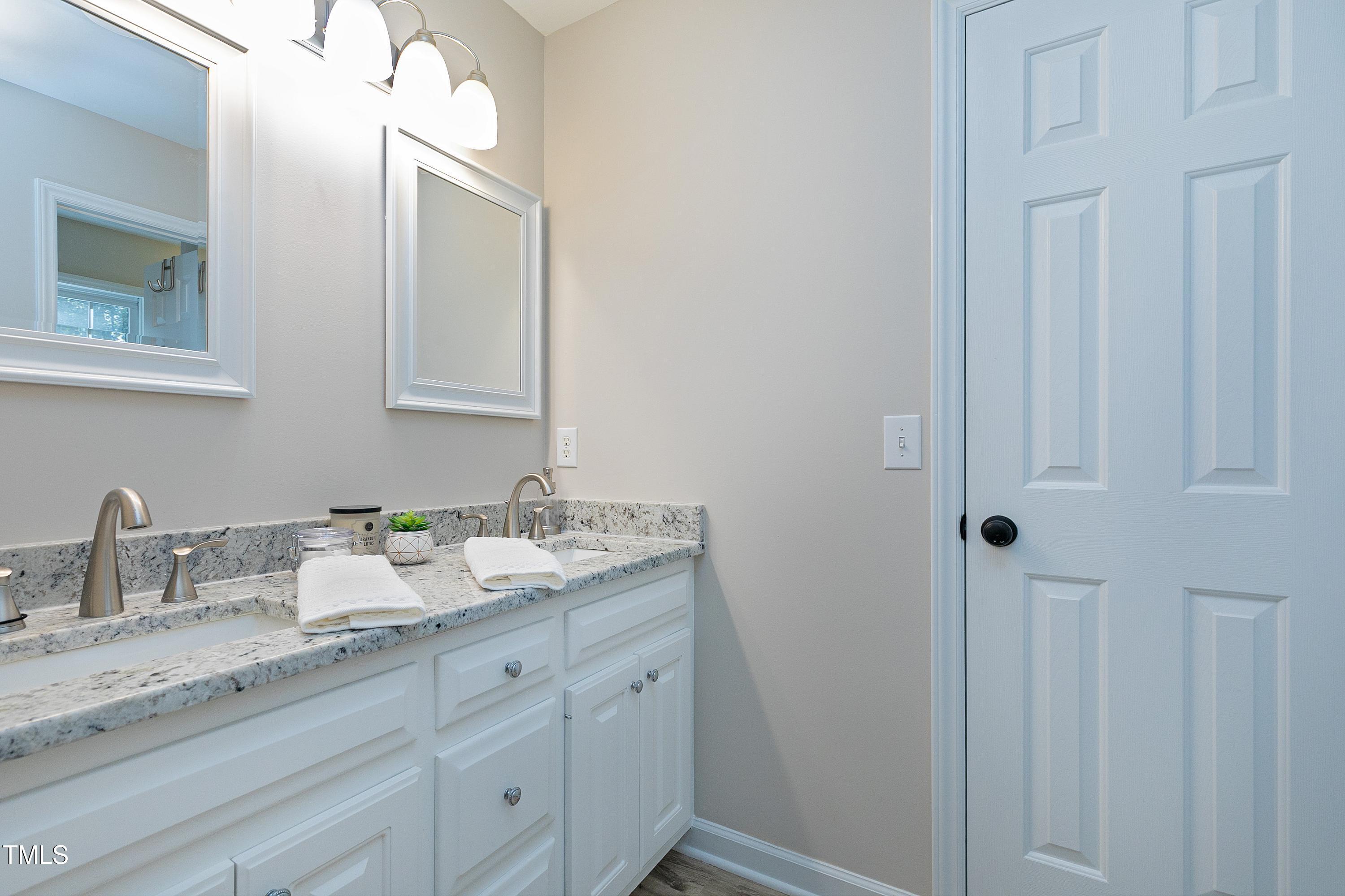 7834 James Austin Road Willow Spring, NC 27592 - Photo 17 of 46 a bathroom with a granite countertop sink and a mirror