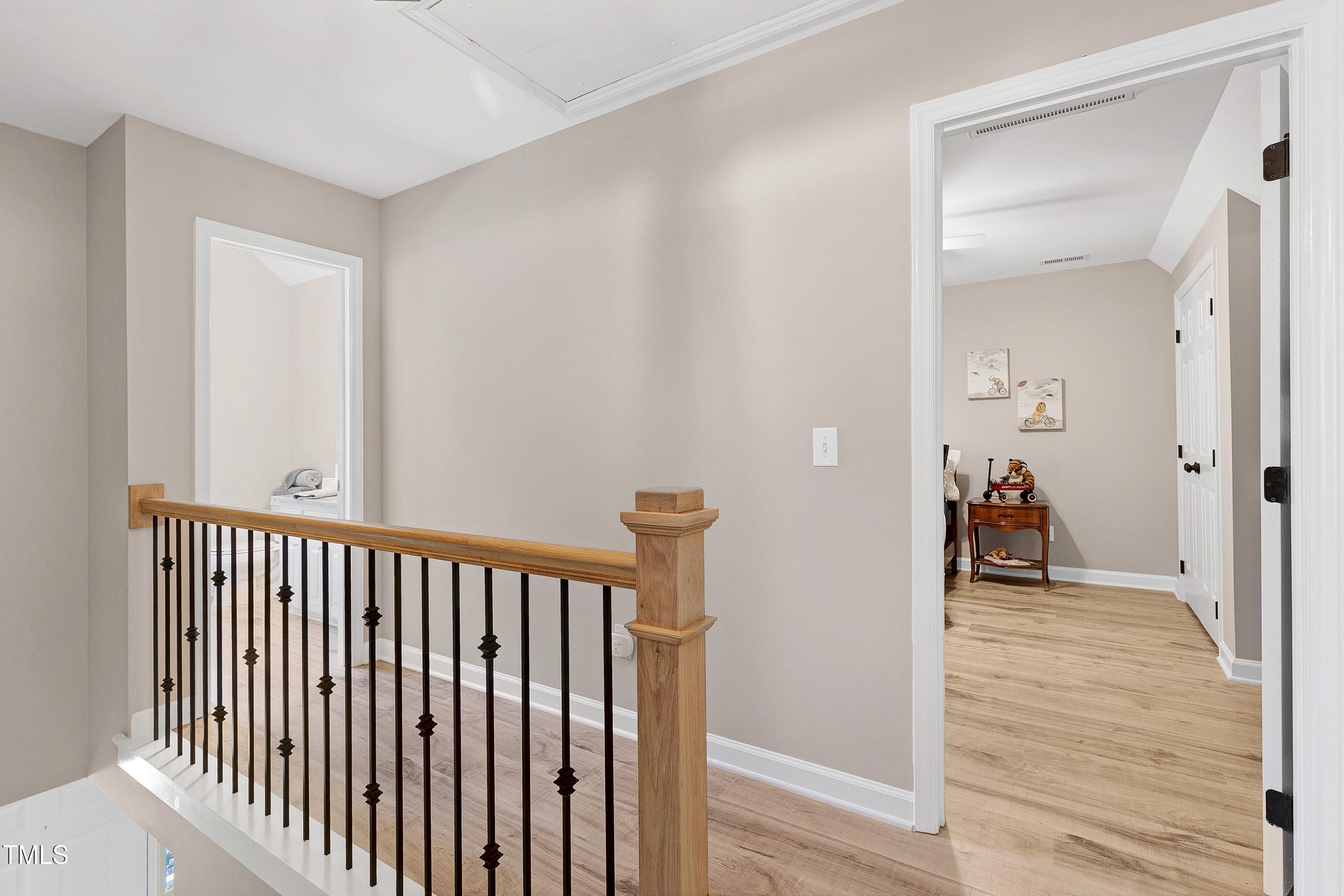 7834 James Austin Road Willow Spring, NC 27592 - Photo 23 of 46 a view of a hallway with wooden floor and stairs
