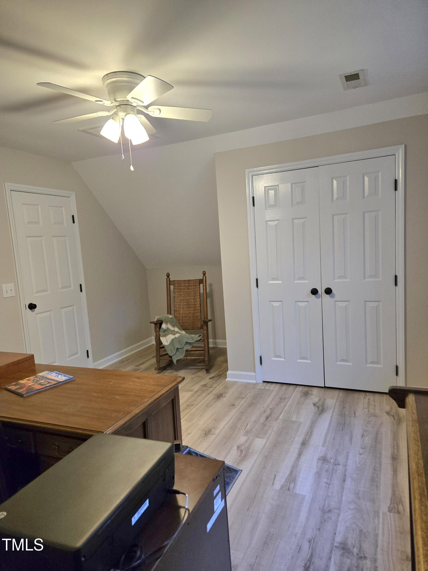 7834 James Austin Road Willow Spring, NC 27592 - Photo 30 of 46 a view of a room with wooden floor and ceiling fan