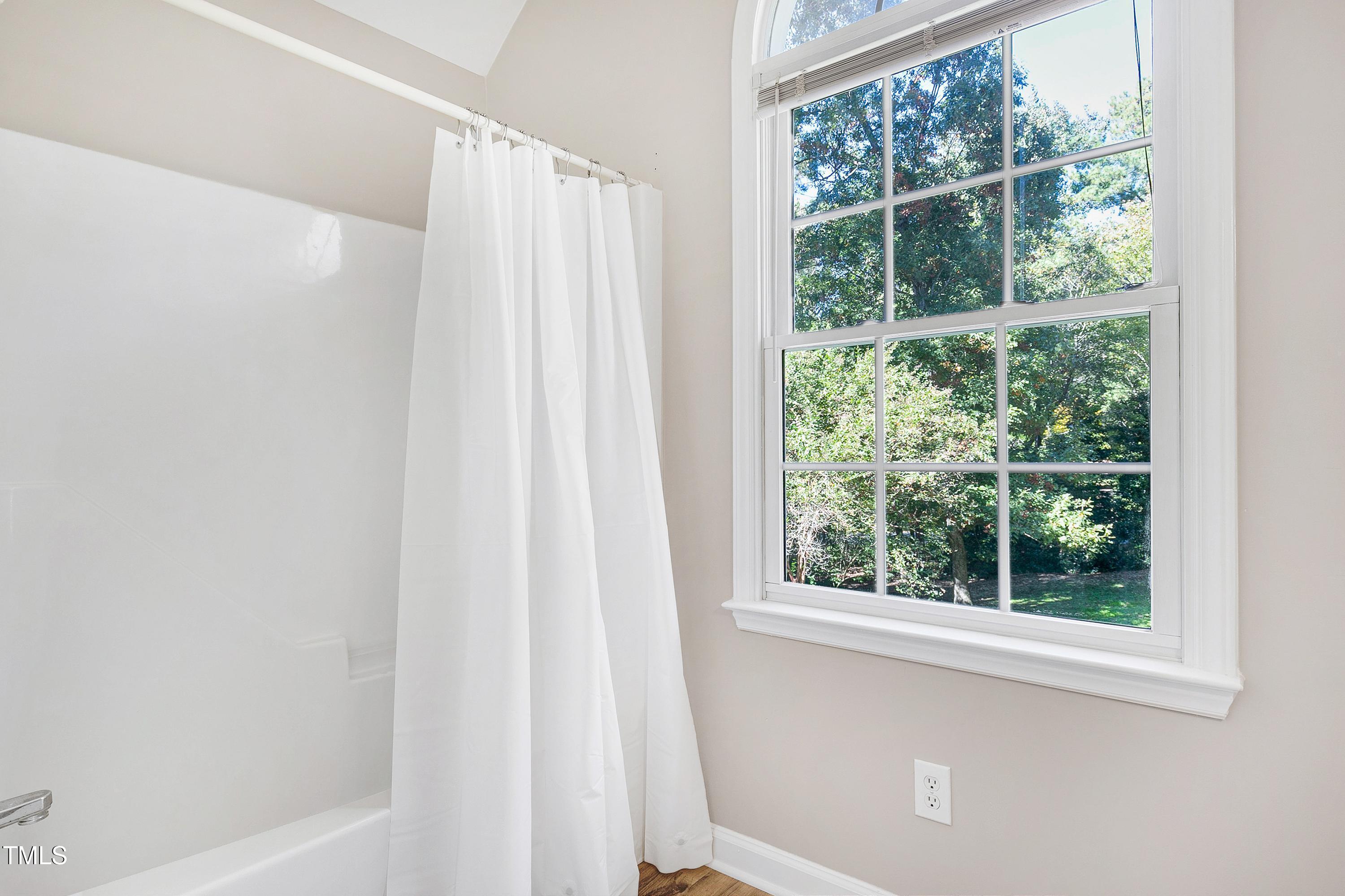 7834 James Austin Road Willow Spring, NC 27592 - Photo 32 of 46 a bathroom with a shower and a window