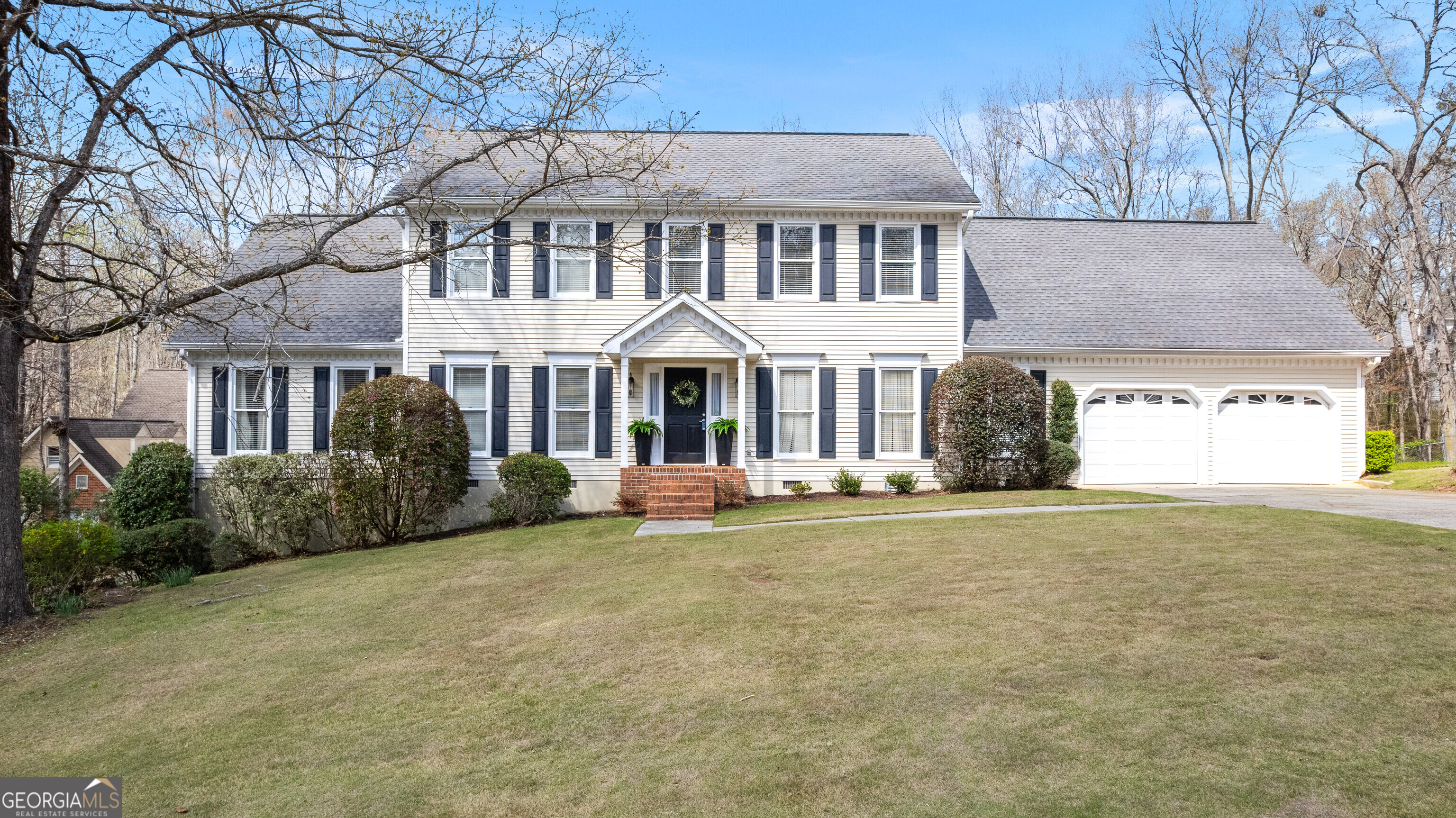 206 Huntington Court Macon, GA 31210 - Photo 1 of 27 a front view of a house with a garden and trees