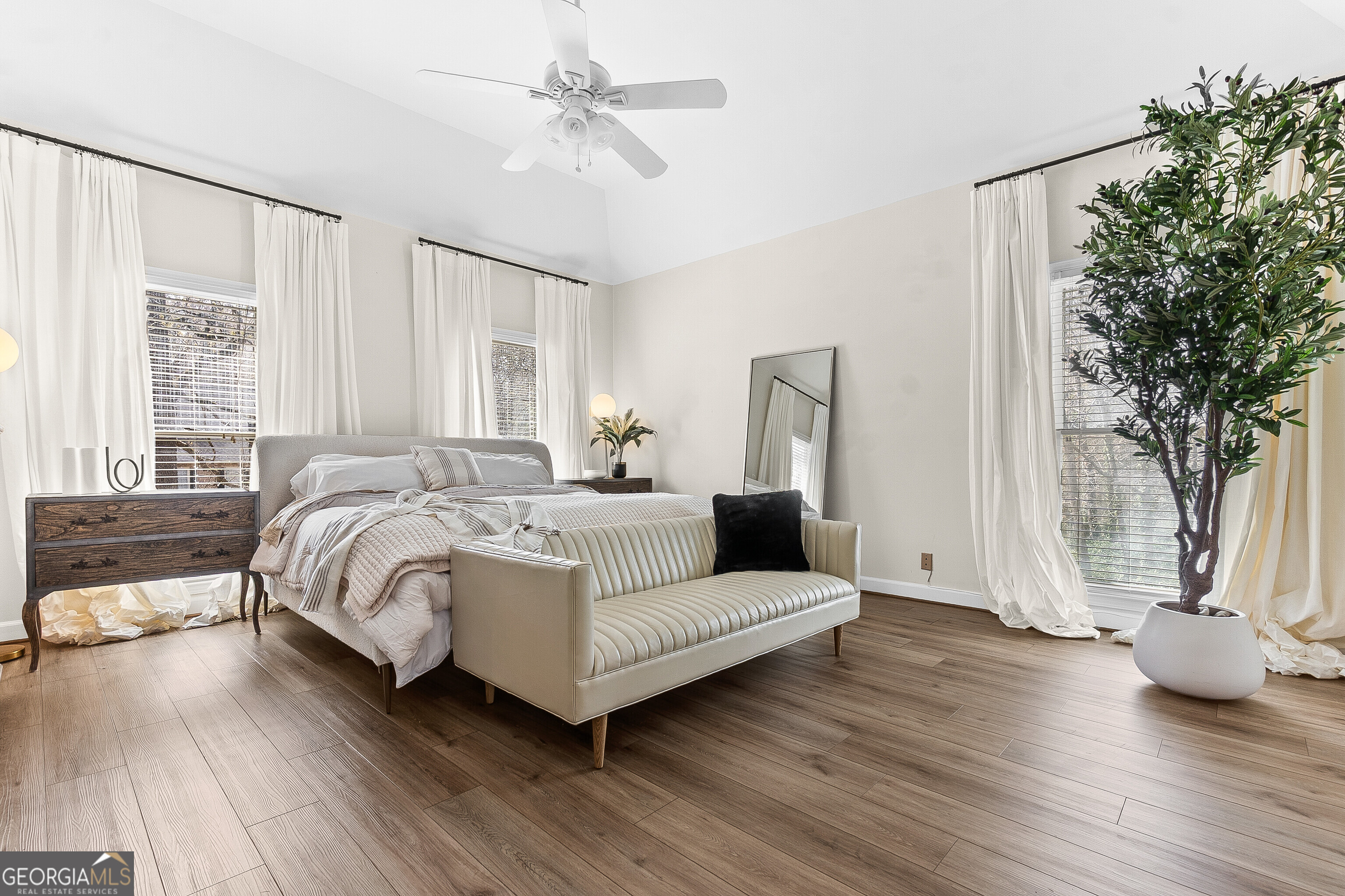 206 Huntington Court Macon, GA 31210 - Photo 15 of 27 a spacious bedroom with a bed a couch and large window
