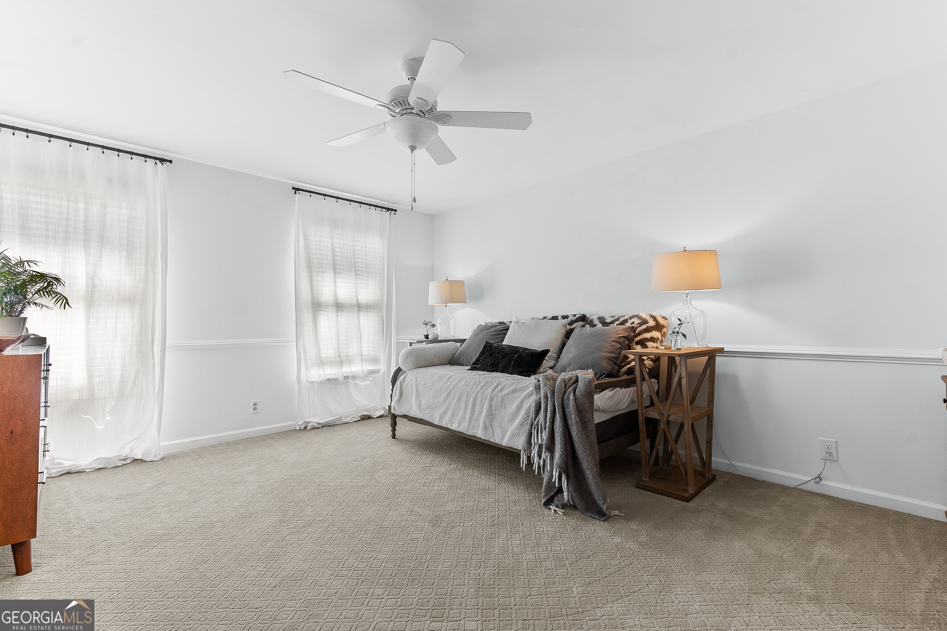 206 Huntington Court Macon, GA 31210 - Photo 23 of 27 a spacious bedroom with a bed and a chandelier