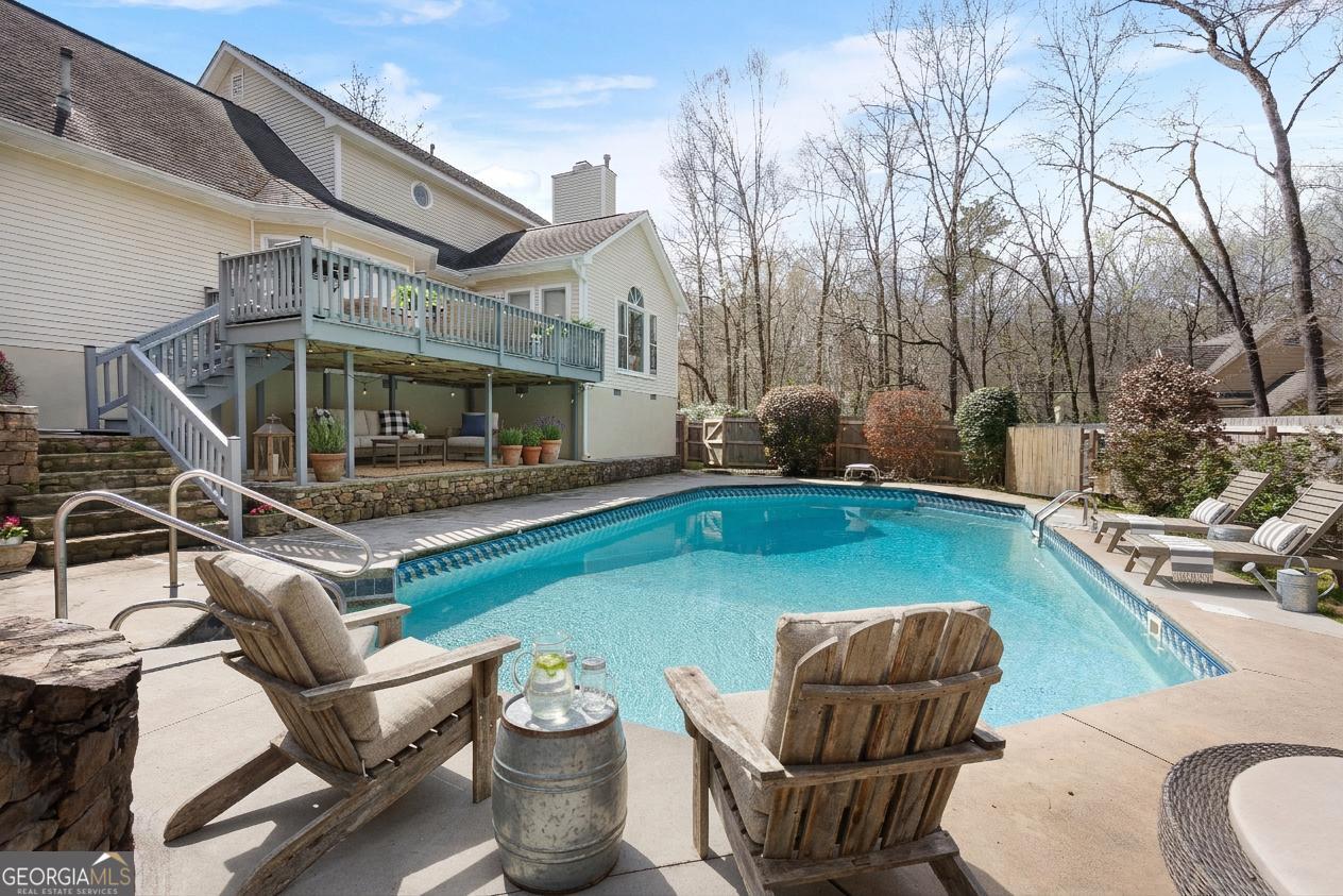 206 Huntington Court Macon, GA 31210 - Photo 27 of 27 a view of a patio with couches table and chairs under an umbrella