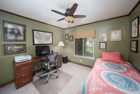 413 South Valley Street Ridgecrest, CA 93555 - Photo 18 of 40 a bedroom with a bed and a chandelier