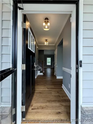 a view of entryway and hall with dining area