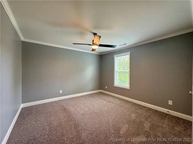 an empty room with windows and cabinet