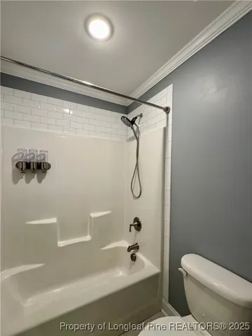 a bathroom with a shower a toilet and sink