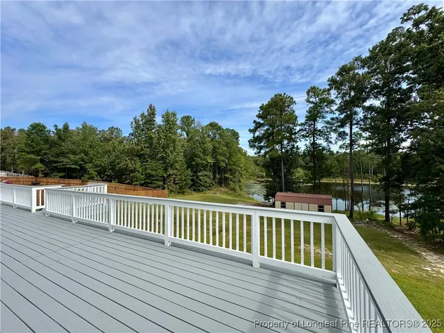 a view of balcony with wooden floor and fence