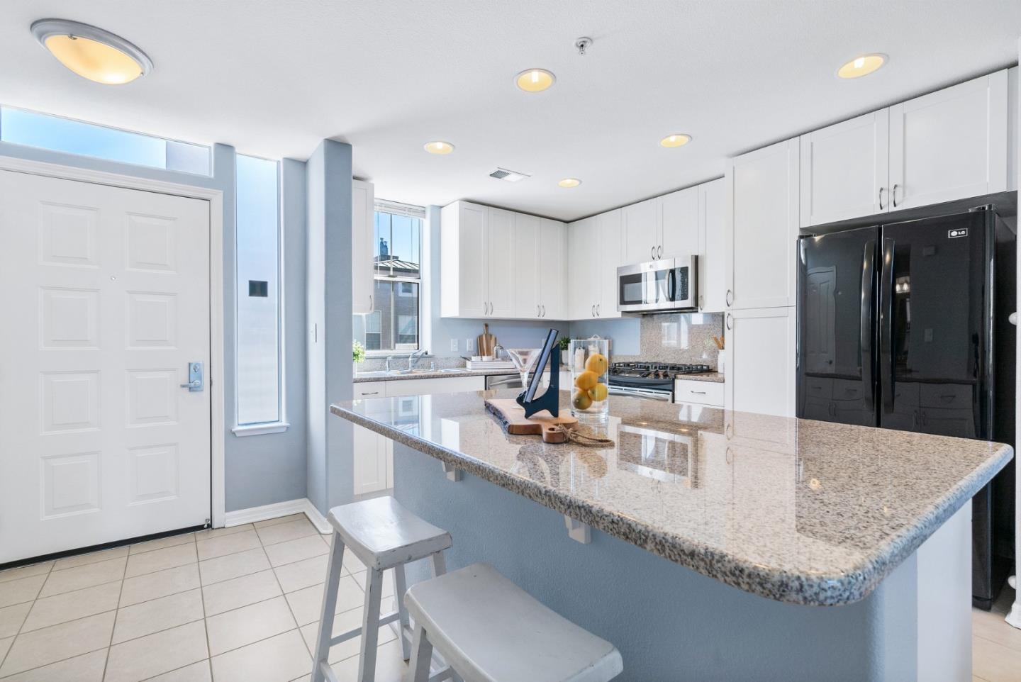 3901 Lick Mill Boulevard, Unit 407 Santa Clara, CA 95054 - Photo 16 of 39 a kitchen with stainless steel appliances granite countertop a sink a stove a refrigerator and cabinets