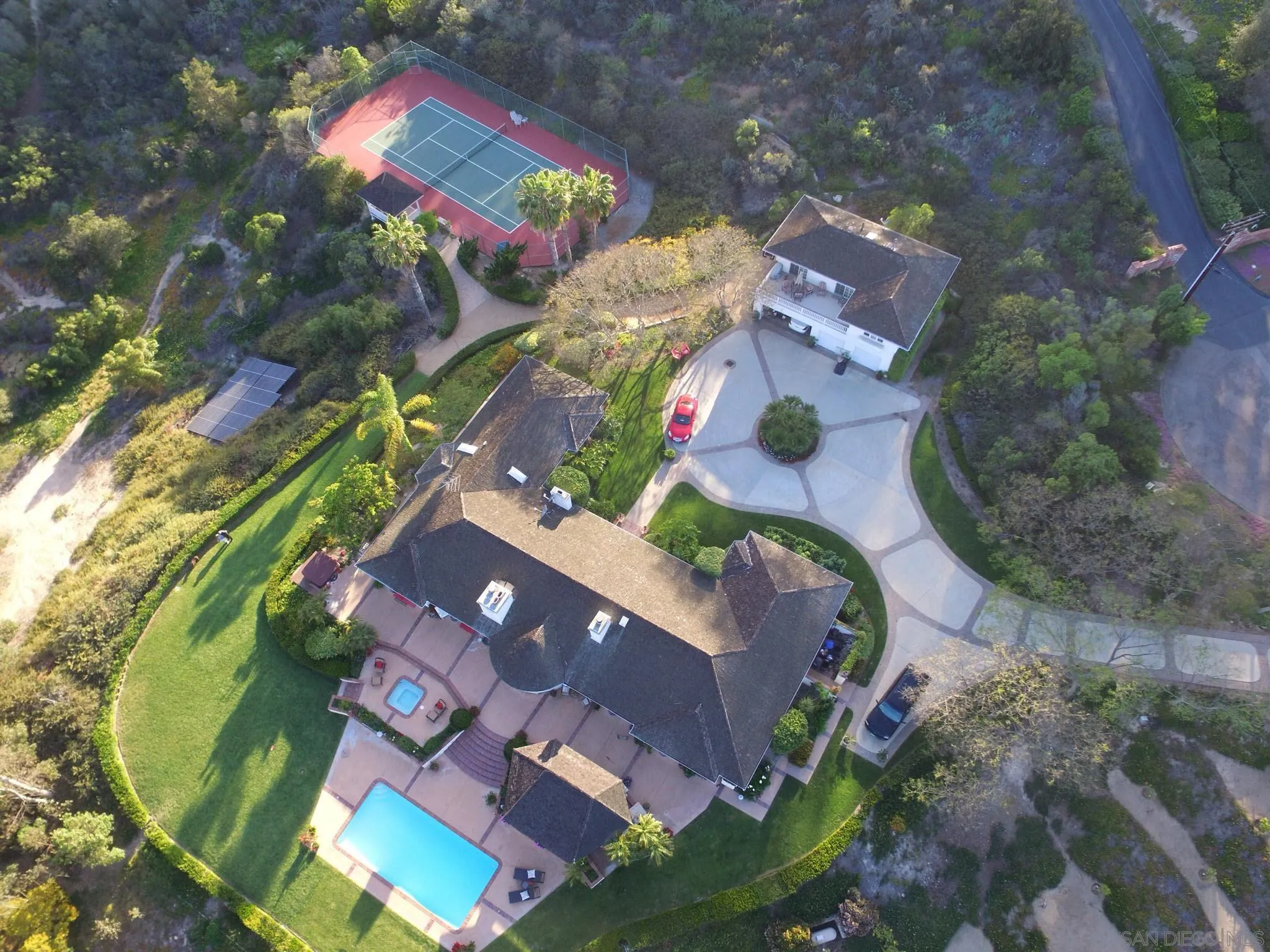 an aerial view of a house with a swimming pool