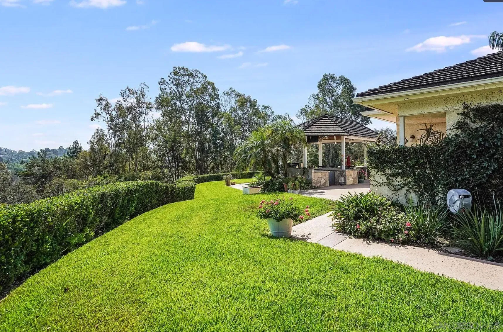 4701 El Mirar Rancho Santa Fe, CA 92067 - Photo 5 of 9 a front view of a house with garden