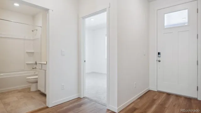 a bathroom with a granite countertop toilet and a sink