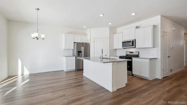 a kitchen with stainless steel appliances a refrigerator sink and microwave