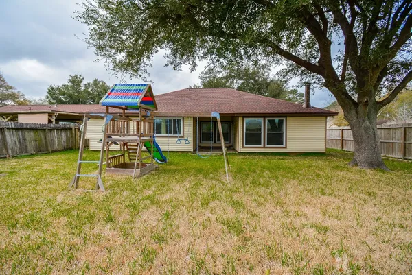 a house that has a tree in front of it