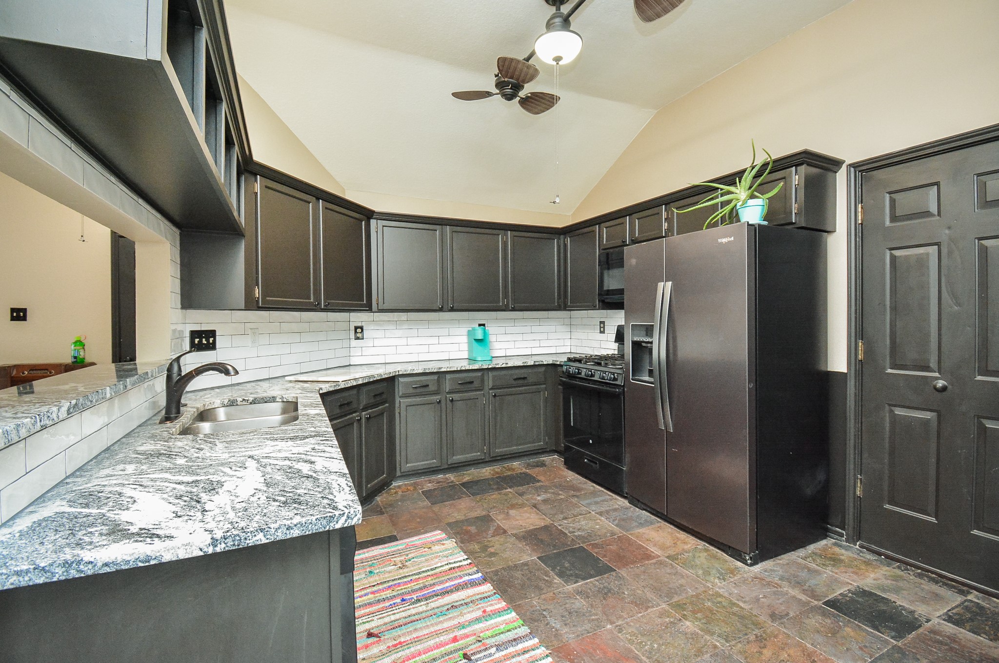 23734 Canyon Lake Drive Spring, TX 77373 - Photo 10 of 32 a kitchen with stainless steel appliances granite countertop a sink refrigerator and cabinets