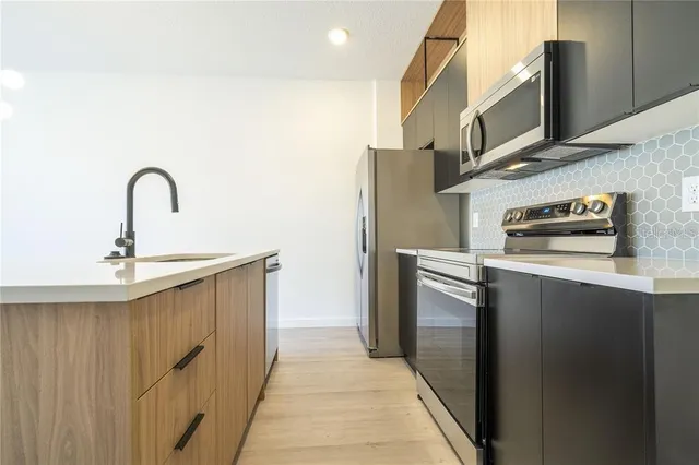 a kitchen with stainless steel appliances a refrigerator and a sink
