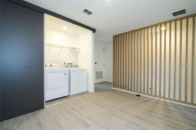 a utility room with cabinets washer and dryer