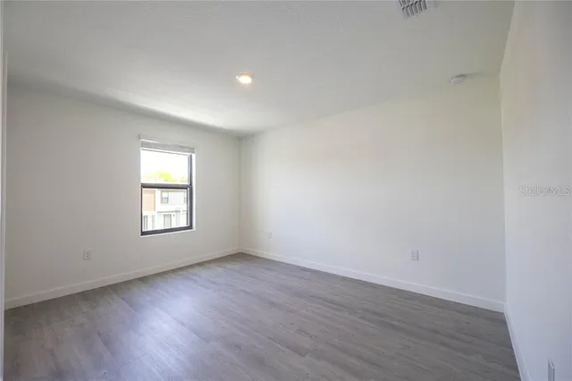 a bathroom with a granite countertop sink toilet and mirror