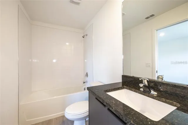 a view of an empty room and wooden floor