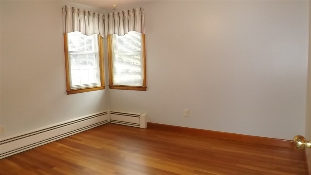 48 Ernest Avenue Worcester, MA 01604 - Photo 22 of 41 a view of an empty room with wooden floor and a window