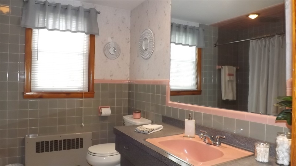 48 Ernest Avenue Worcester, MA 01604 - Photo 25 of 41 a bathroom with a sink toilet a mirror and window
