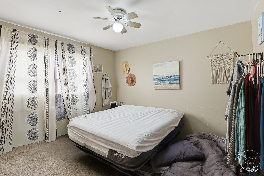 618-620 South Main Street Grant Park, IL 60940 - Photo 16 of 21 a bedroom with a large bed and a chandelier
