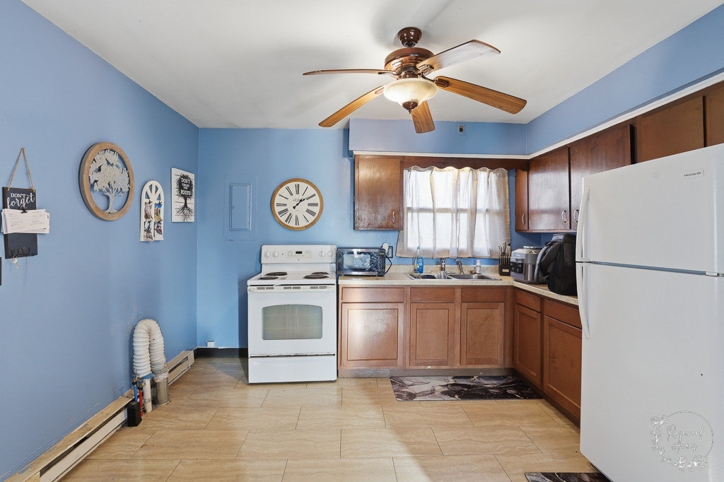 618-620 South Main Street Grant Park, IL 60940 - Photo 2 of 21 a kitchen with a refrigerator and a clock