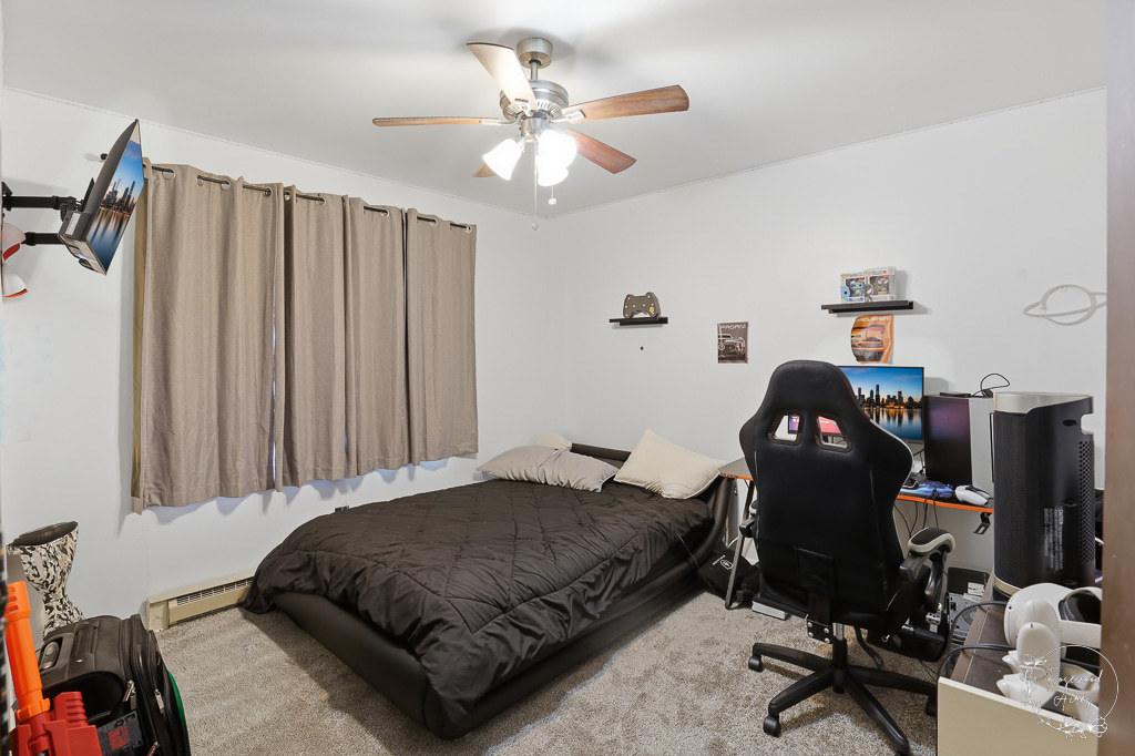 618-620 South Main Street Grant Park, IL 60940 - Photo 8 of 21 a bedroom with a bed and a chandelier
