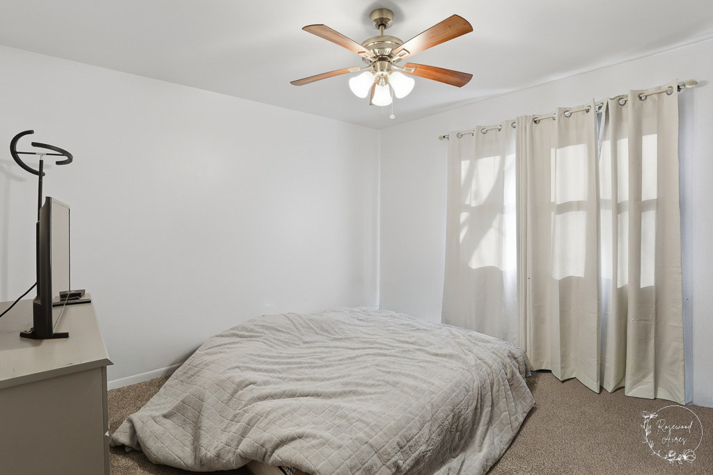 618-620 South Main Street Grant Park, IL 60940 - Photo 9 of 21 a bedroom with a bed and a chandelier