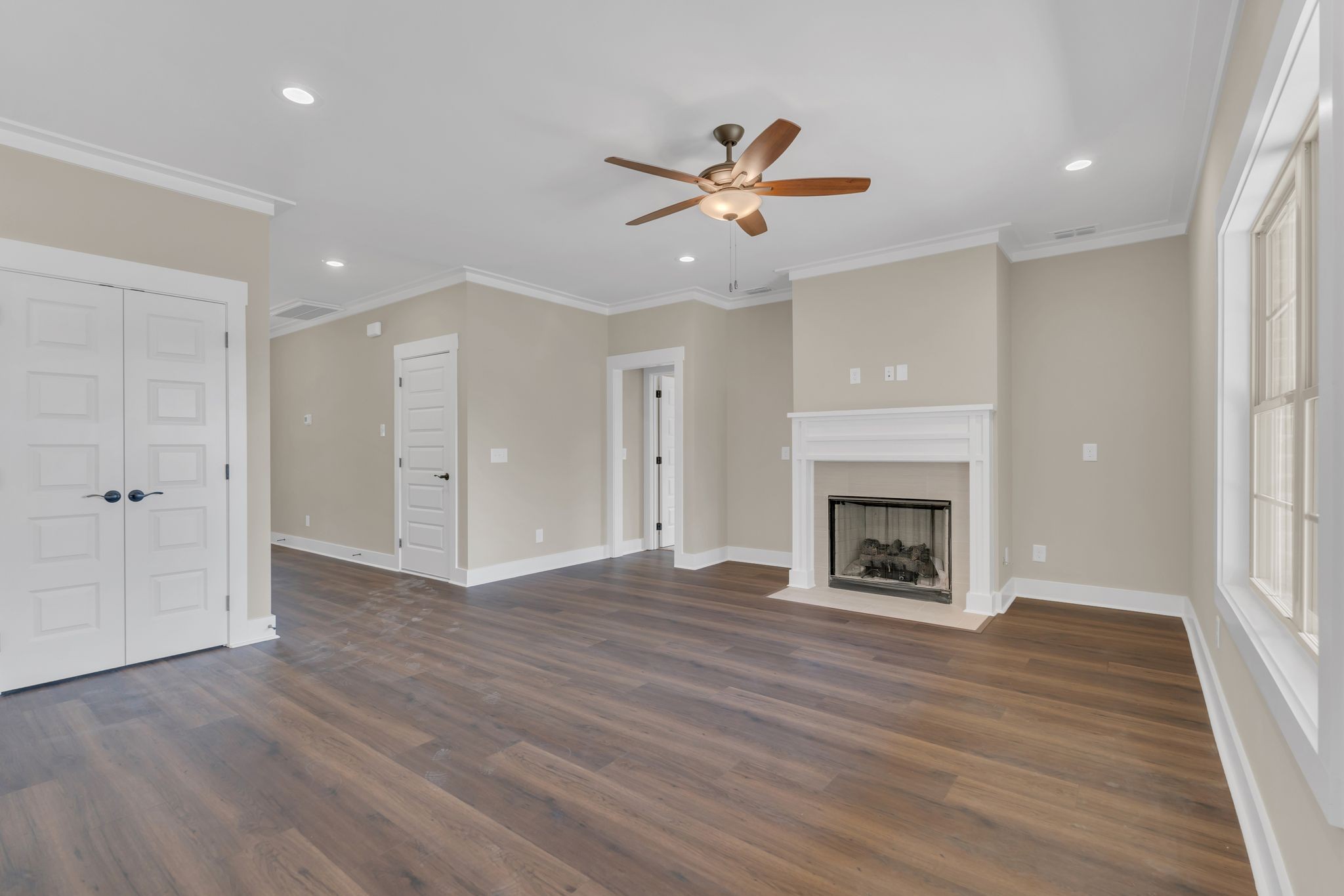 1170 Rimrock Road Smyrna, TN 37167 - Photo 8 of 33 an empty room with wooden floor fireplace and windows