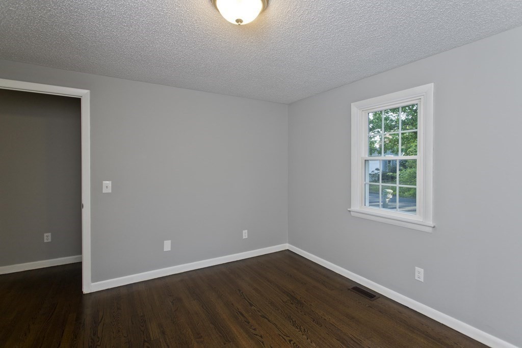 75 Saffron Circle Springfield, MA 01129 - Photo 24 of 42 an empty room with wooden floor and windows