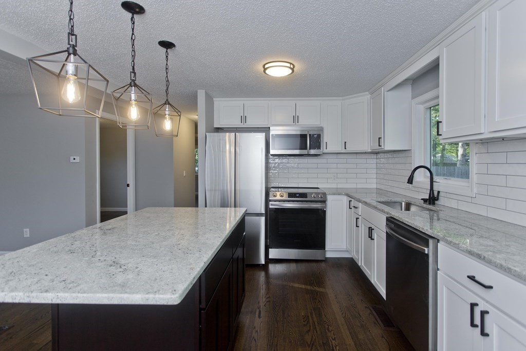 75 Saffron Circle Springfield, MA 01129 - Photo 8 of 42 a kitchen with stainless steel appliances granite countertop a sink stove and refrigerator
