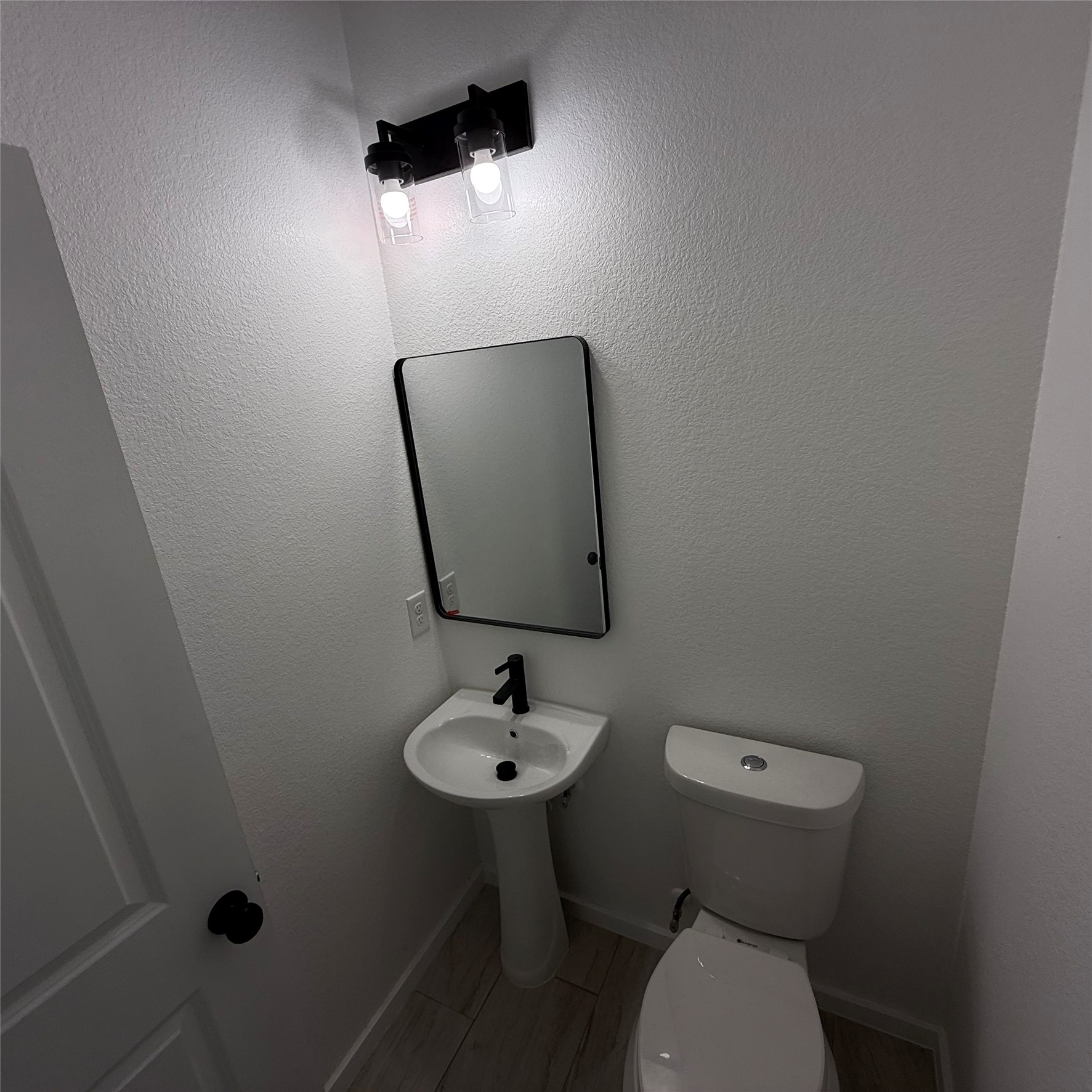 118 Crazy Cross Road Wimberley, TX 78676 - Photo 8 of 18 a bathroom with a toilet sink and mirror