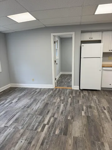 a view of workspace with wooden floor and window