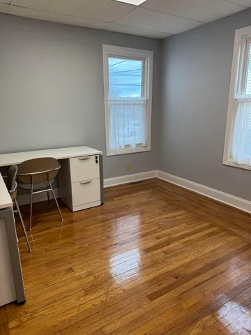 a kitchen with granite countertop a stove and white cabinets