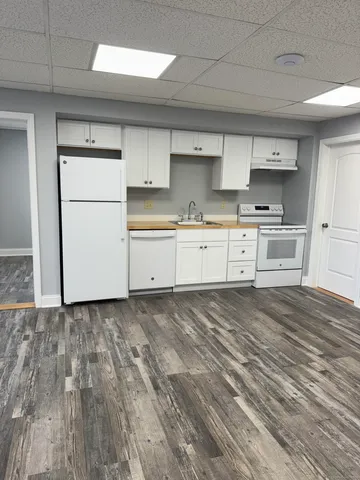 a view of an empty room and wooden floor