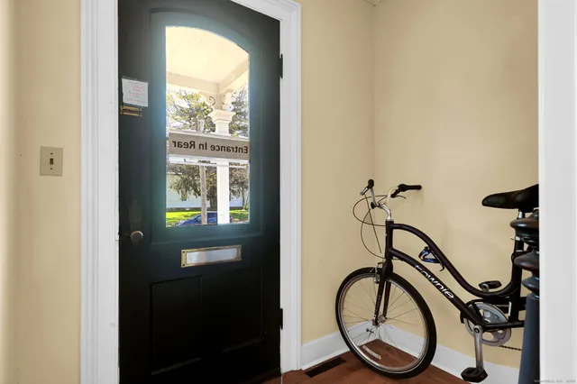 a work room with furniture a flat screen tv and a fireplace