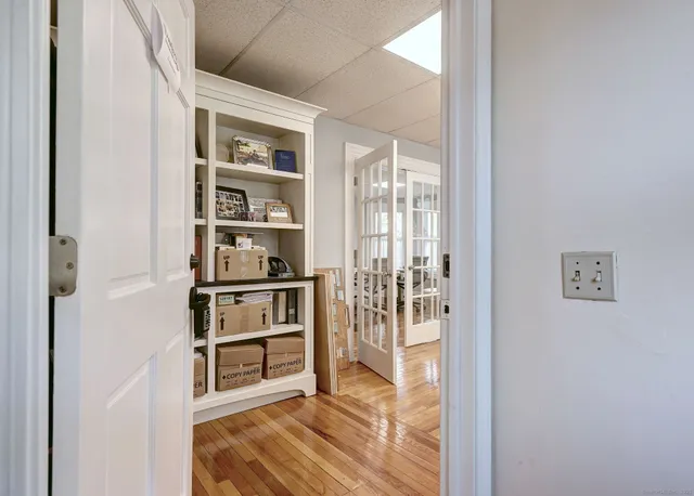 a workspace with furniture and a wooden floor
