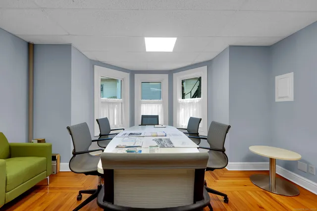 a room with lots of chairs and mirrors