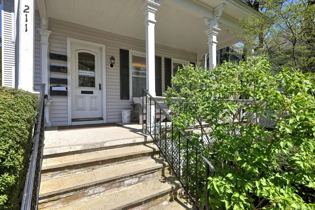 a front view of a residential houses with yard