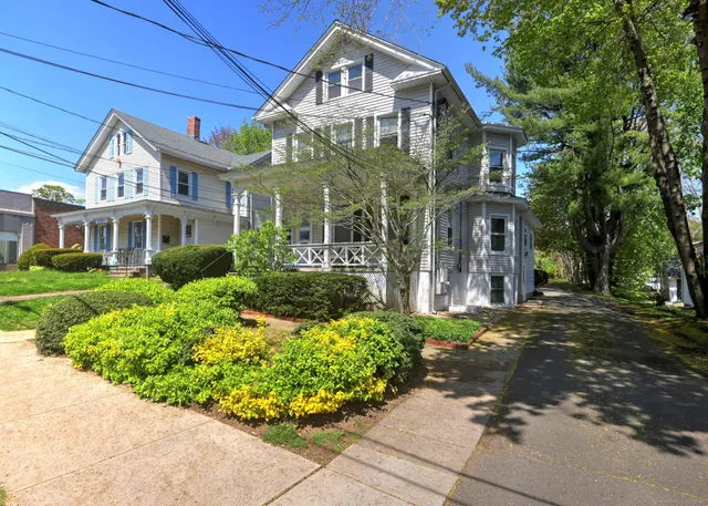 a white toilet sitting next to a window
