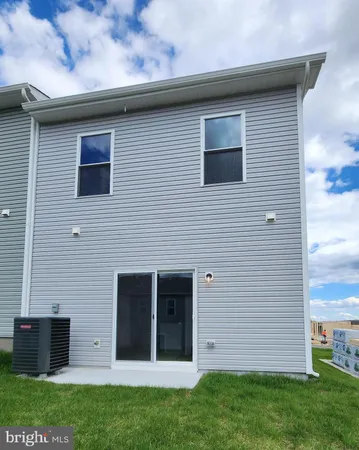 a kitchen with stainless steel appliances granite countertop a stove top oven a refrigerator a sink and dishwasher with wooden floors